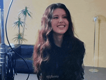 a woman with long hair is smiling and has the name njfaerie written on the bottom