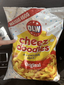 someone is holding a bag of cheez doodles