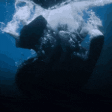 a person is swimming in the ocean with bubbles coming out of their mouths