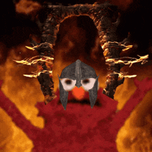 elmo wearing a helmet stands in front of a burning statue