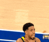 a blurry picture of a basketball player with the nba logo on the bottom