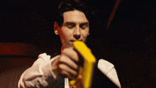 a man with blood on his face is holding a piece of paper