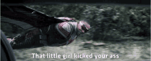 a man in a superhero suit is flying through the air with the words that little girl kicked your ass written below him