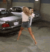 a woman is standing in front of a bmw with a license plate that says 28at123