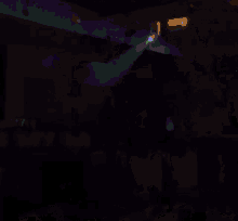 a blurry picture of a man in a white shirt in a purple light
