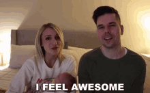 a man and a woman holding a baby with the words i feel awesome behind them