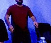 a man with a beard wearing a red shirt