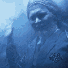 a man in a suit and tie is giving a thumbs up in a blurry photo by johnnydepp gifs