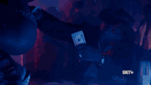 a bet logo can be seen in the corner of a dark room