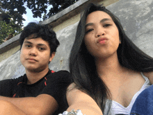 a man and a woman are posing for a selfie