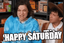 a man and a woman are sitting on a couch with the words `` happy saturday '' written on the bottom .
