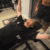a man laying on a bench with a shirt that says 83