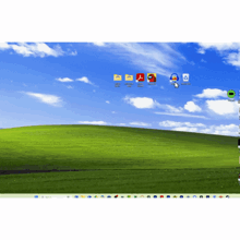 a computer screen with a green hill in the background and a bunch of icons