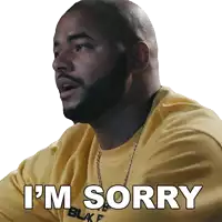 a man wearing a yellow shirt that says i 'm sorry on it