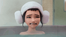 a girl in a bathtub with a towel on her head and ear muffs