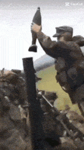 a soldier is holding a bottle in his hand while another soldier holds a gun