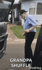 a man in a blue shirt is standing next to a car with the words grandpa shuffle written on the bottom