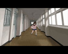 a girl in a pink sweater is walking down a hallway