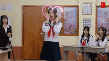 a girl in a school uniform is holding a pink heart in her hand
