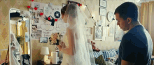 a bride and groom are standing next to each other in front of a poster that says trust me