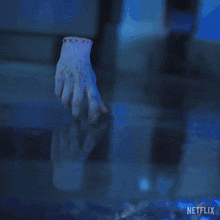 a close up of a hand with a netflix logo on the bottom right