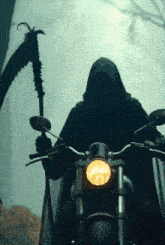 grim reaper riding a motorcycle with a scythe
