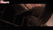 a close up of a person holding a gun with the words kulfy in the upper right corner
