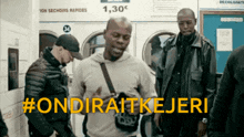 a group of men are standing in a laundromat with the hashtag #ondiraitkejeri