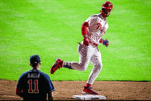 a baseball player with the number 11 on his jersey is running