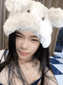 a woman wearing a white furry hat with ears