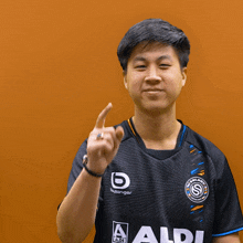 a man wearing a black shirt that says aldi is giving the middle finger