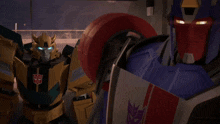 two transformers are standing next to each other and one of them has the word transformers on it
