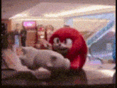 a stuffed animal is standing next to another stuffed animal in a room .