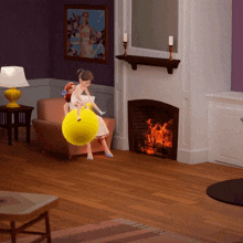 a girl sitting on a yellow ball in a living room