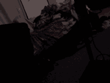 a dark room with a blanket on the floor and a sign on the wall that says happiness