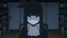 a girl with black hair and blue eyes is sitting in front of a bookshelf