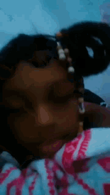 a close up of a person 's face with a bracelet on their head .