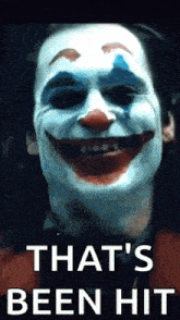 a close up of a clown 's face with the words `` that 's been hit '' written on it .
