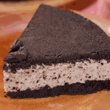 a slice of oreo pie is on a wooden surface