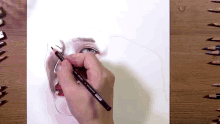 a person drawing a woman 's face with a pencil that says ' prismacolor ' on it