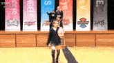 a group of people standing on a stage with banners behind them including one that says hate