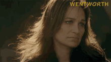 a close up of a woman 's face with the word wentworth on the bottom right