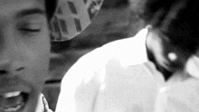 a black and white photo of a man wearing a hat that says ' nyc ' on it