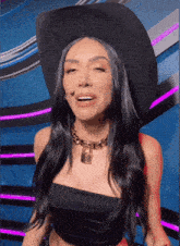 a woman wearing a cowboy hat and a necklace with a padlock on it