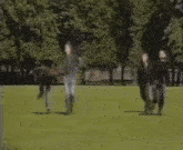 a blurry picture of three people walking in a park