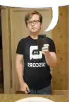 a man taking a selfie in front of a mirror while wearing a black shirt that says discord