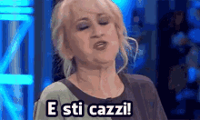 a woman is making a funny face and says e sti cazzi !