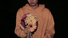 a blurry picture of a person wearing an orange hoodie