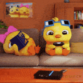 two cartoon ducks are sitting on a couch and one is reading a book