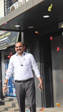 a man stands in front of a building that says language academy on it